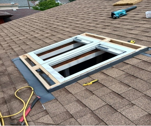 Skylight frame installation in progress on a residential roof
